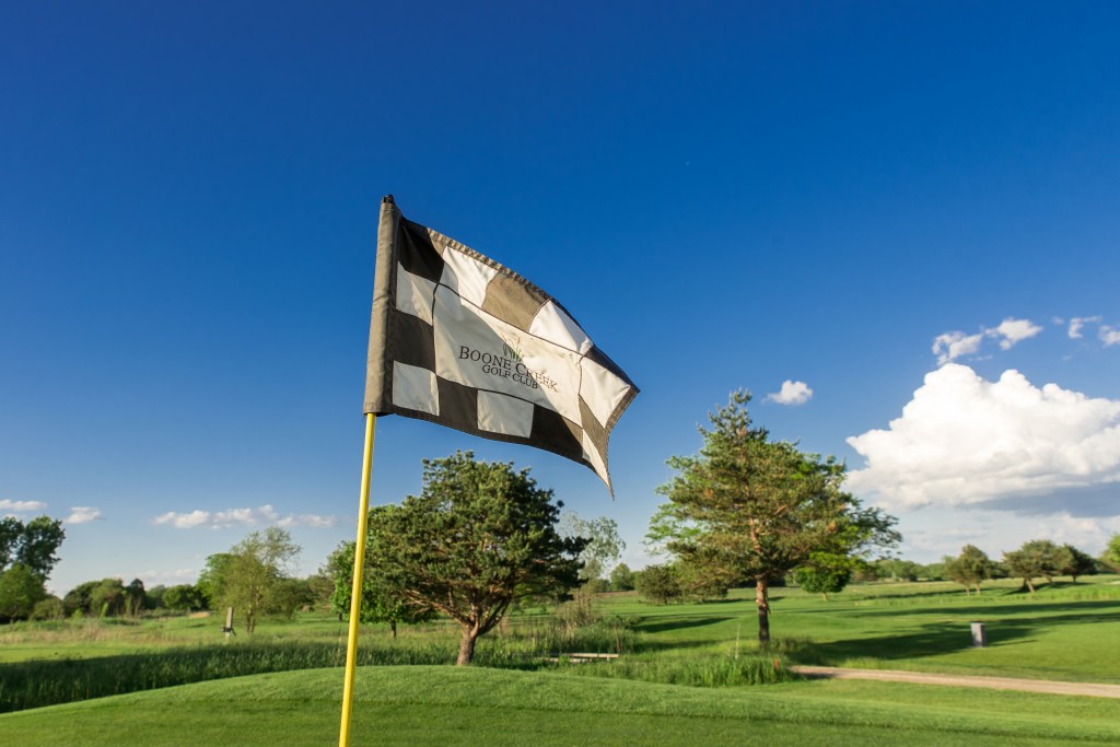 Flag standing on golf course 